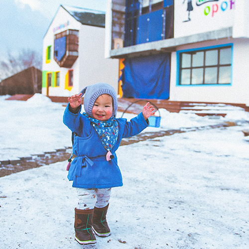 save plus project demo-a kid happily playing in the field.